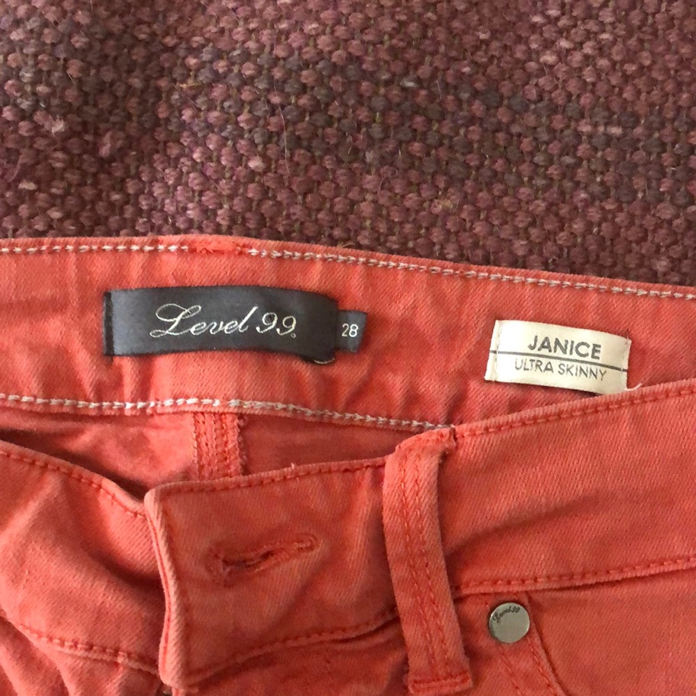Level 99 jeans size 28  oranges/peach color